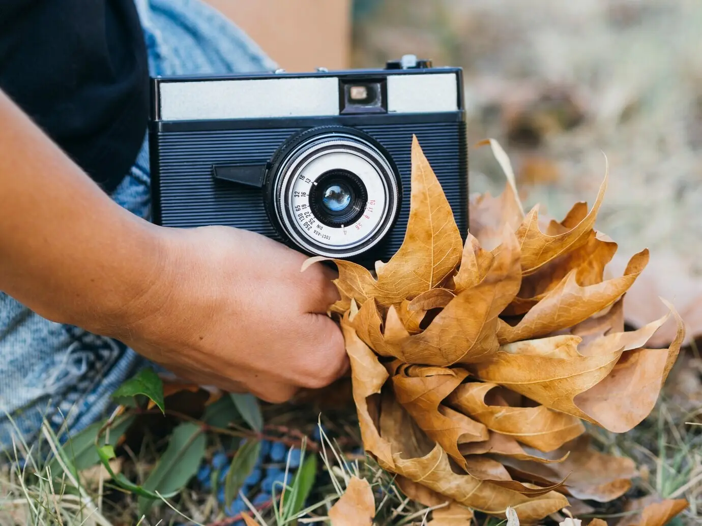 Close-up view of a photo camera in a woman's hands.
