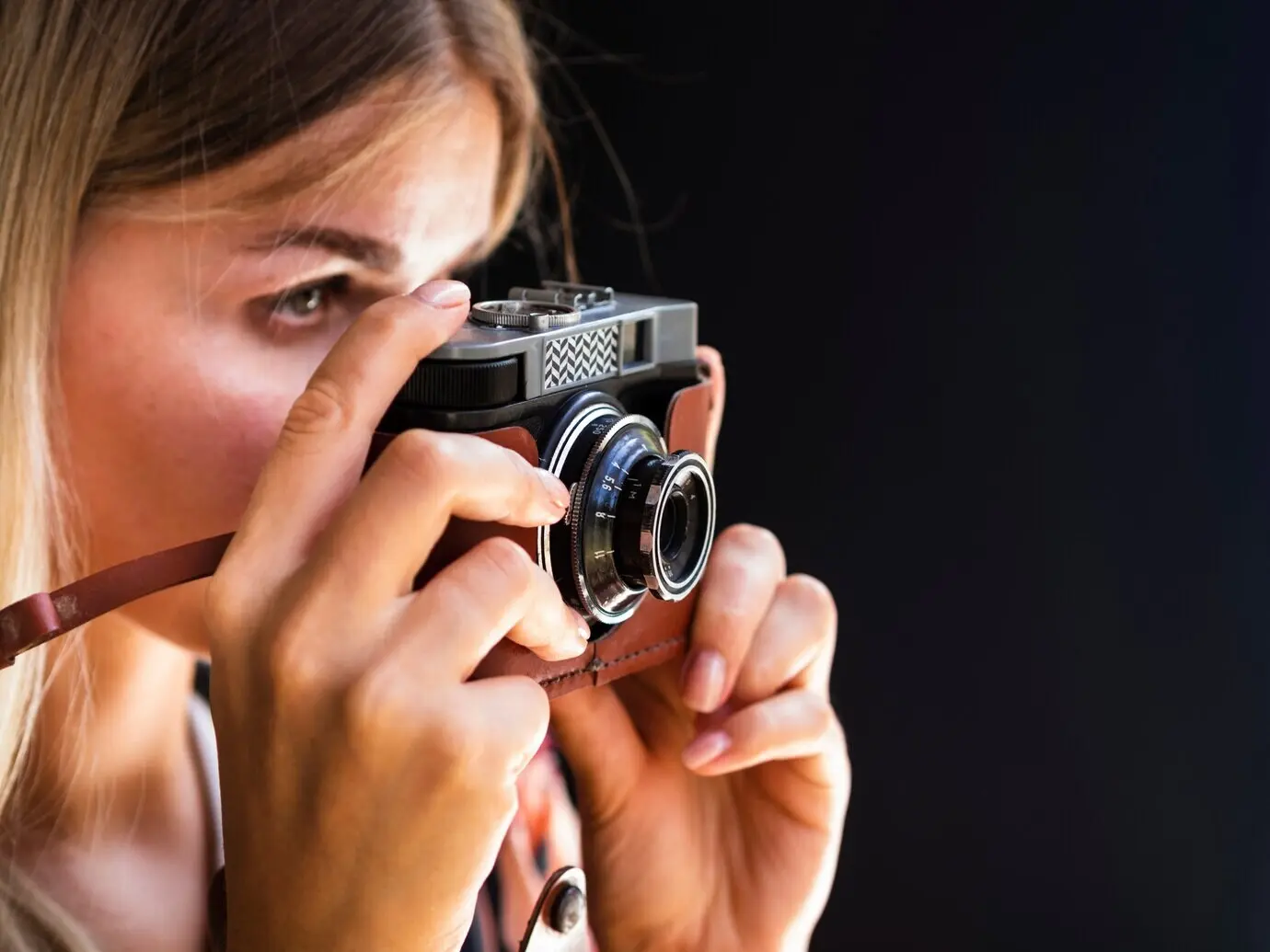 A woman taking photos with a camera.